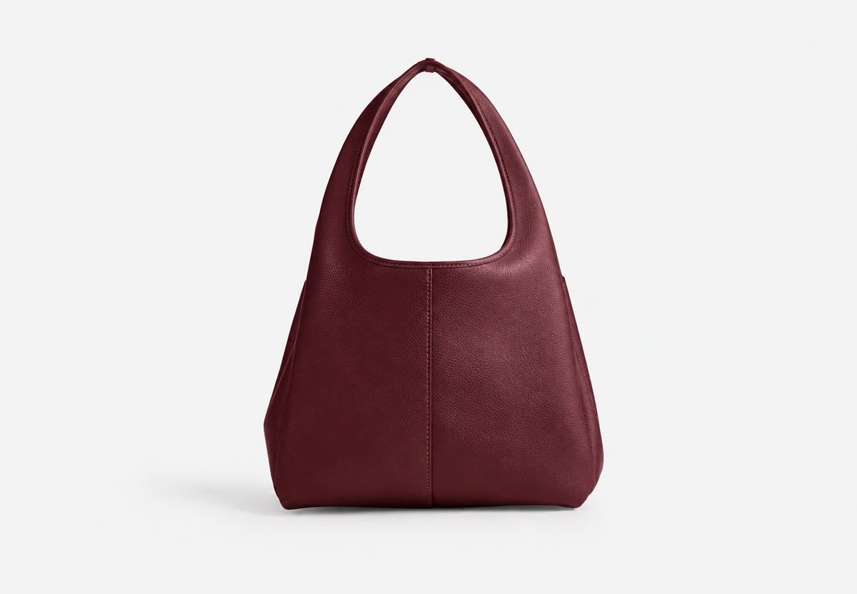 Back of burgundy pebble leather tote bag with a centre seam and curved handles
